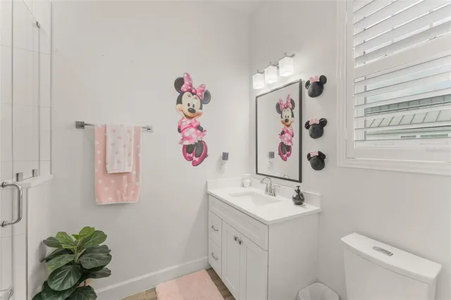 a bathroom with a sink vanity and toilet