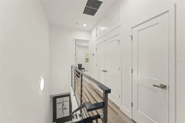 a bedroom with a bed a couch and a large window