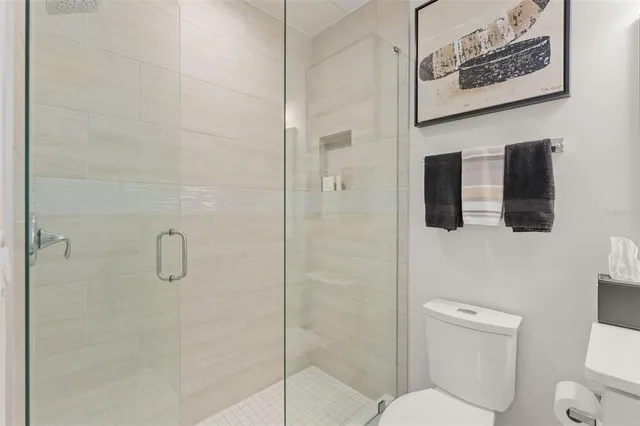 a bathroom with a toilet and shower