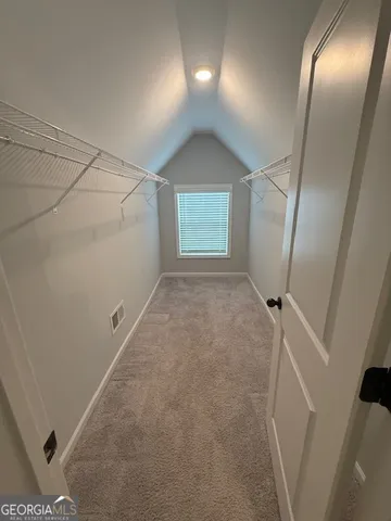 a bathroom with a sink mirror and a shower