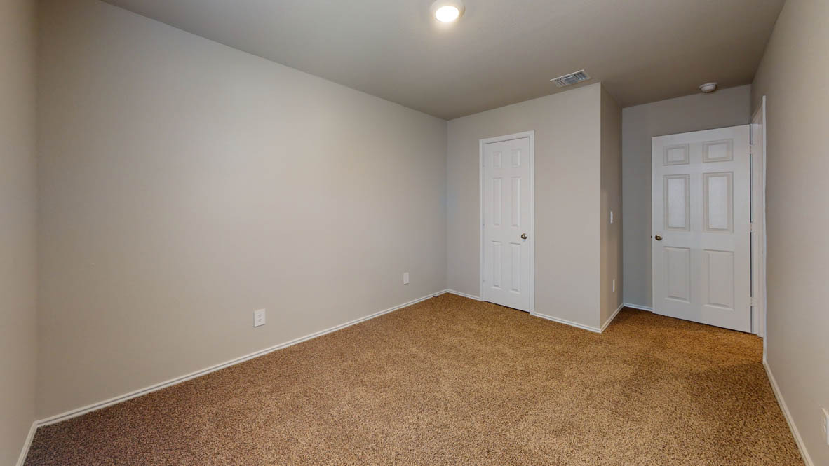 596 Hector Loop Georgetown, TX 78626 - Photo 11 of 14 A spacious room offers comfortable carpet flooring and simple, functional design, ready for personal touches.