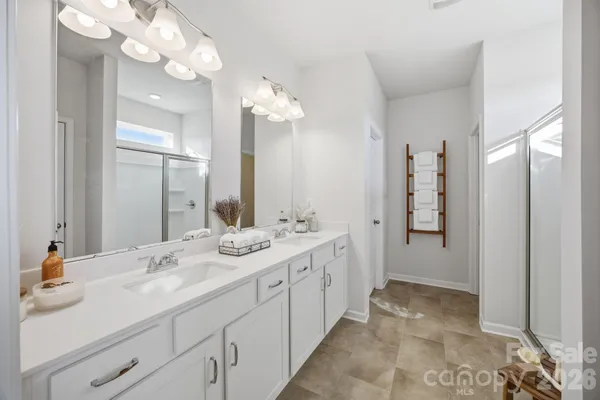 a bathroom with a glass shower door