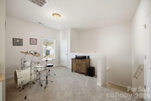 a kitchen with a sink a refrigerator and white cabinets