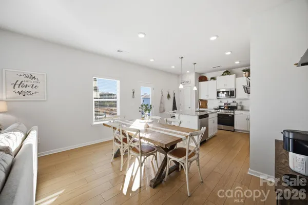 a view of a dining room with furniture and wooden floor
