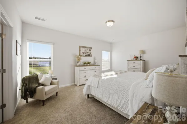 a bedroom with a bed and a couch