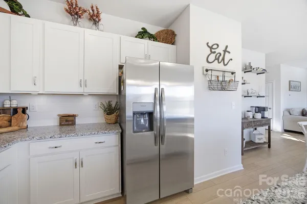 a kitchen with a refrigerator and cabinets