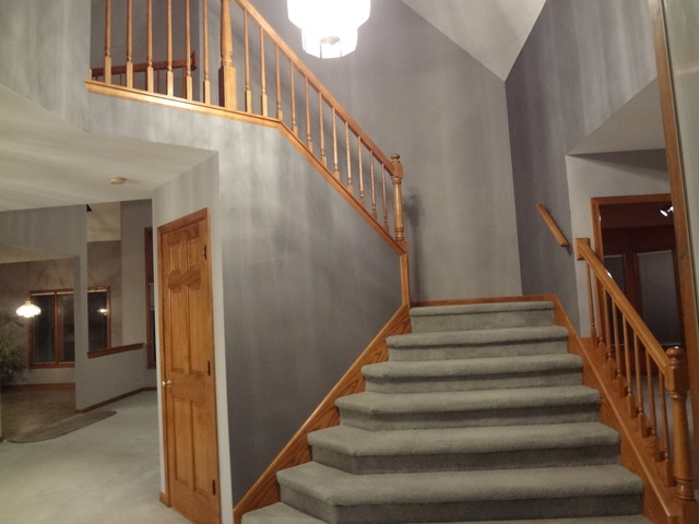 13336 Round Barn Road Plainfield, IL 60585 - Photo 2 of 25 a view of staircase with lots of frames on wall and a window