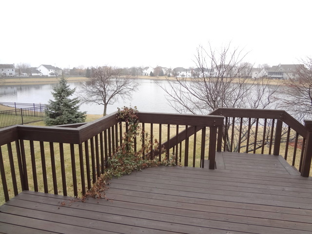 13336 Round Barn Road Plainfield, IL 60585 - Photo 22 of 25 a balcony with wooden floor and fence