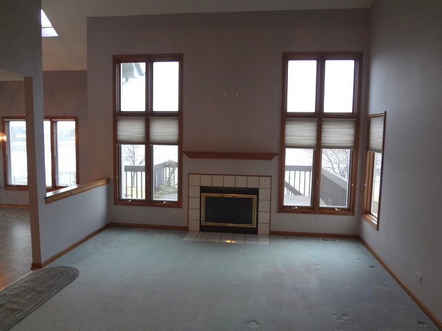 13336 Round Barn Road Plainfield, IL 60585 - Photo 5 of 25 an empty room with windows and fireplace