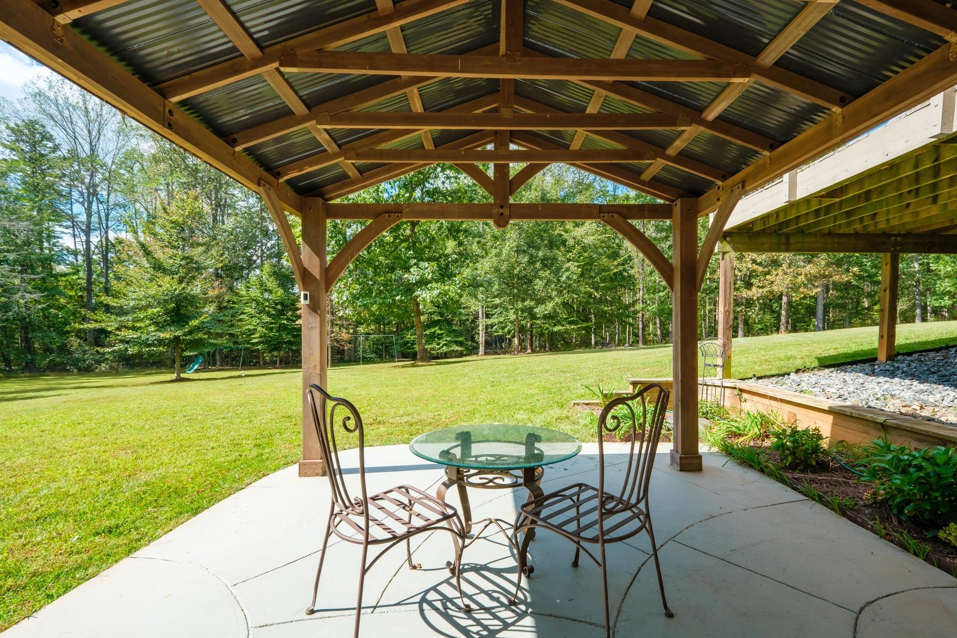 909 Hancock Drive Ruckersville, VA 22968 - Photo 53 of 68 a view of a swimming pool with a table chairs and a backyard