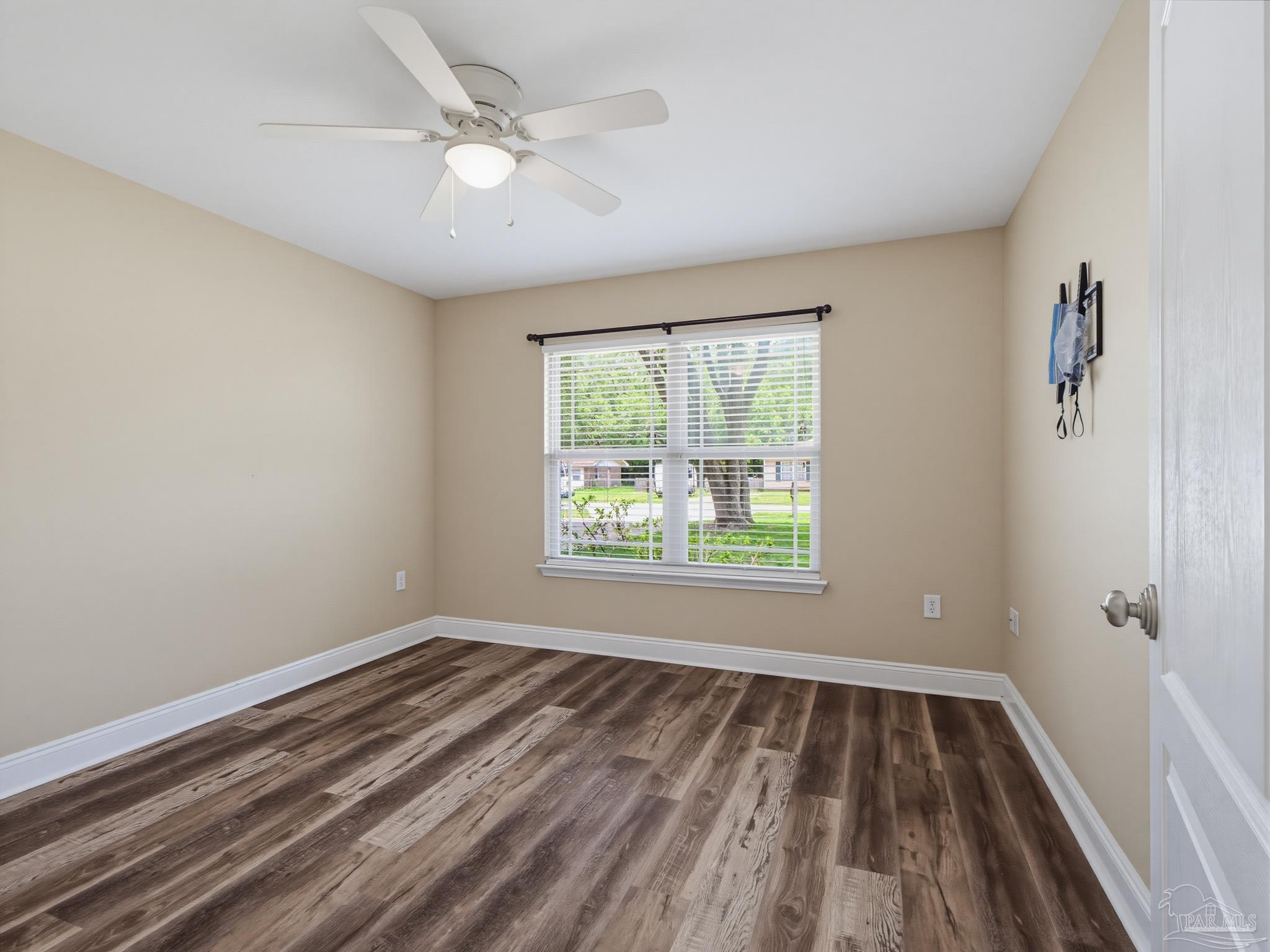 5567 Jones Street Milton, FL 32570 - Photo 39 of 48 wooden floor in an empty room with a window