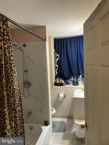 a bathroom with a bathtub and shower