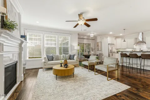 a living room with furniture and kitchen view