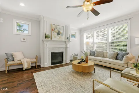 a room with wooden floor and a potted plant