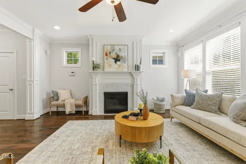 a living room with kitchen island furniture and a dining table with wooden floor