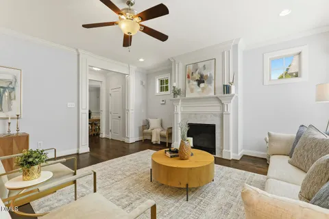 a kitchen with stainless steel appliances granite countertop a sink a stove a refrigerator and island with wooden floor