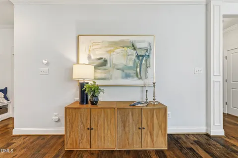 a kitchen with stainless steel appliances granite countertop a sink a stove a window and white cabinets