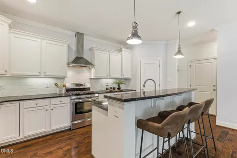 a kitchen with stainless steel appliances a sink stove and cabinets