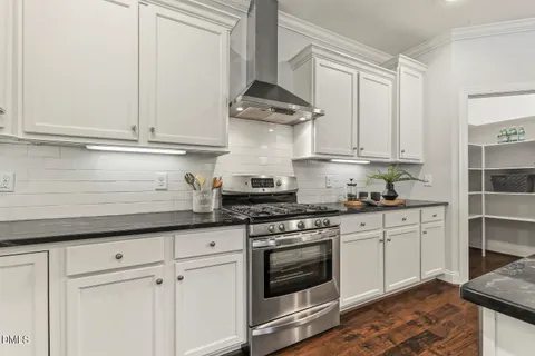 a kitchen with granite countertop white cabinets white appliances and granite counter tops