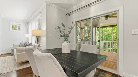 a large bed sitting in a bedroom next to a window and a chandelier