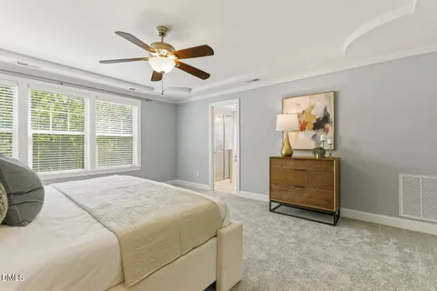 a view of an empty room with wooden floor and a fireplace