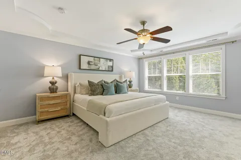 a spacious bedroom with a bed and a chandelier