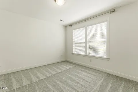 an aerial view of a house with a yard and garden