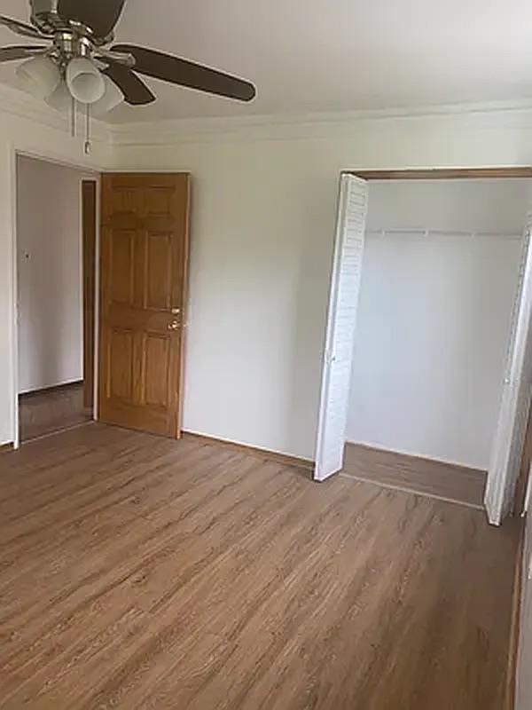 1087 Blake Avenue Brooklyn, NY 11208 - Photo 5 of 16 Unfurnished bedroom with a closet, wood finished floors, a ceiling fan, and ornamental molding
