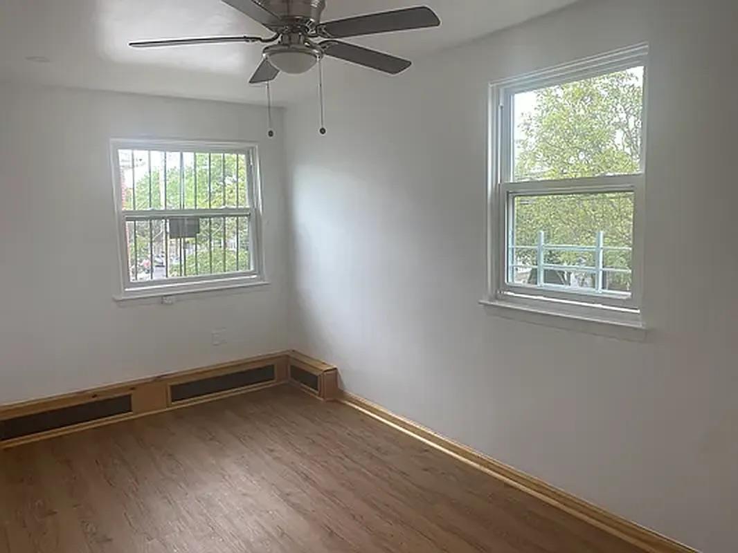 1087 Blake Avenue Brooklyn, NY 11208 - Photo 8 of 16 Spare room with wood finished floors and ceiling fan