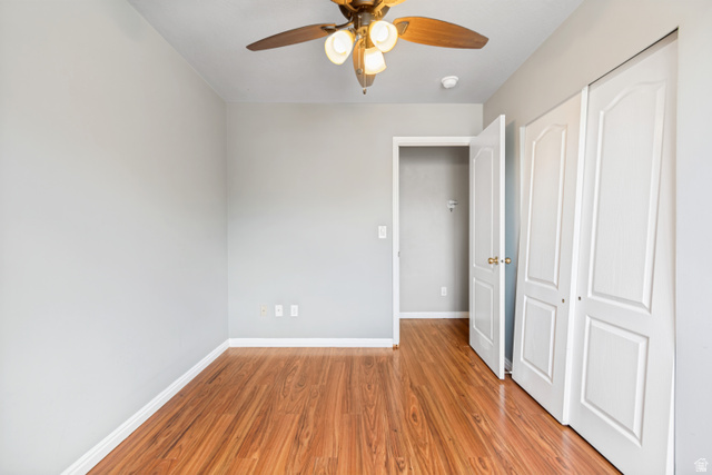843 Deer Flat Road Tooele, UT 84074 - Photo 19 of 27 Room featuring wood-finish flooring, light gray wall paint, white baseboards, and a ceiling fan with integrated lighting