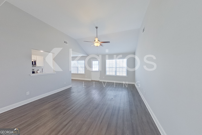 228 Western Red Cedar Drive Springfield, GA 31329 - Photo 4 of 27 a view of an empty room with wooden floor and a window