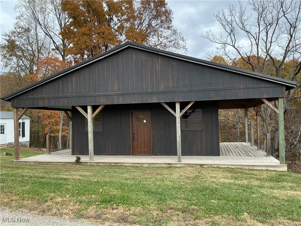 10550 Symmes Creek Road Adamsville, OH 43802 - Photo 1 of 21 View of front of house with a front lawn and a porch