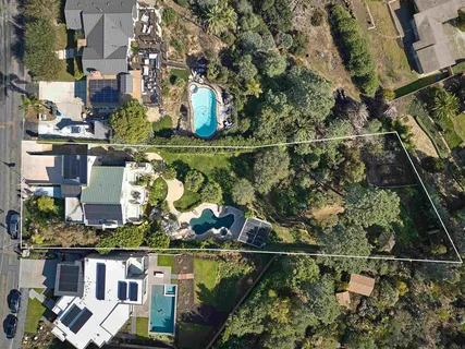 a view of a house with a yard patio and swimming pool