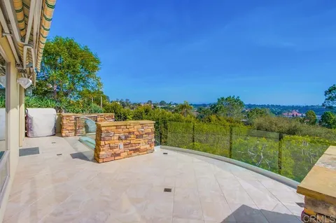 a view of backyard with outdoor seating and green space