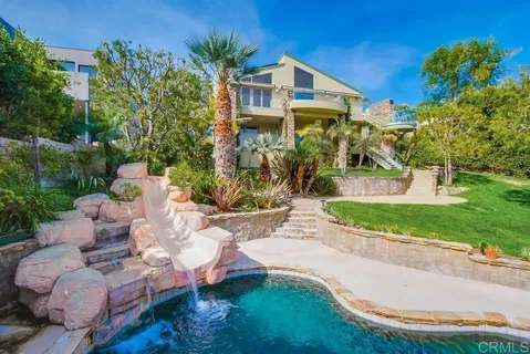a backyard of a house with yard and outdoor seating