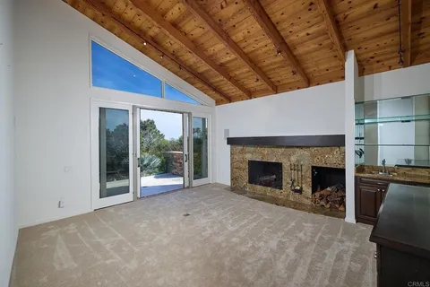 a kitchen with stainless steel appliances granite countertop a sink a stove and a wooden cabinets