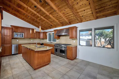 an empty room with furniture and a fireplace