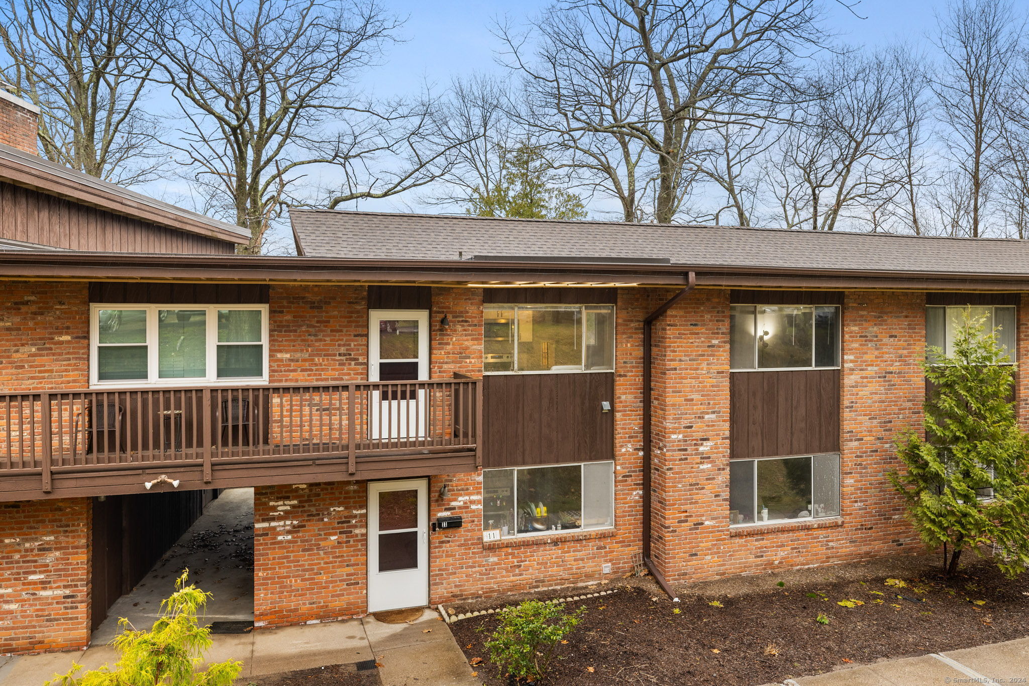 264 Lyman Road, Unit 310 Wolcott, CT 06716 - Photo 1 of 1 a front view of a house with garden