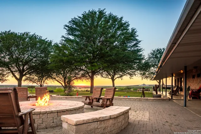 a view of a patio with a table and chairs under an umbrella