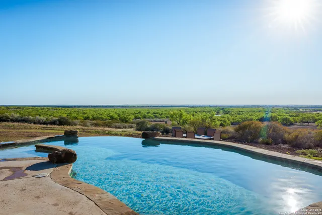 a living room with fireplace furniture and a flat screen tv