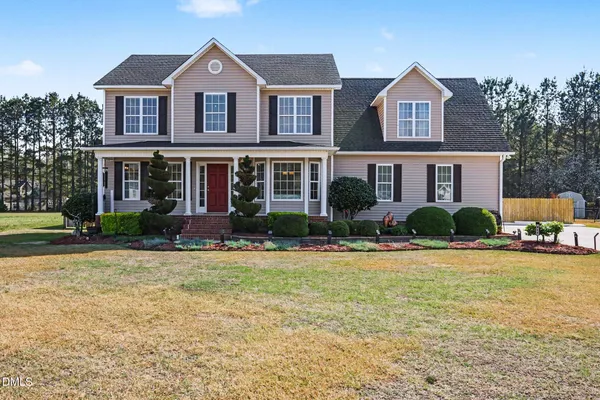 a front view of house with yard and green space
