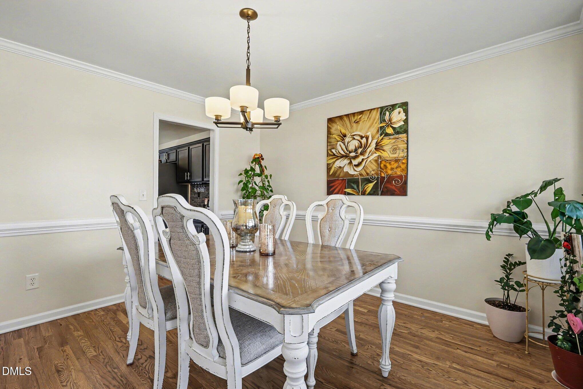 313 Blaze Ridge Drive Smithfield, NC 27577 - Photo 10 of 30 a view of a dining room with furniture wooden floor and chandelier