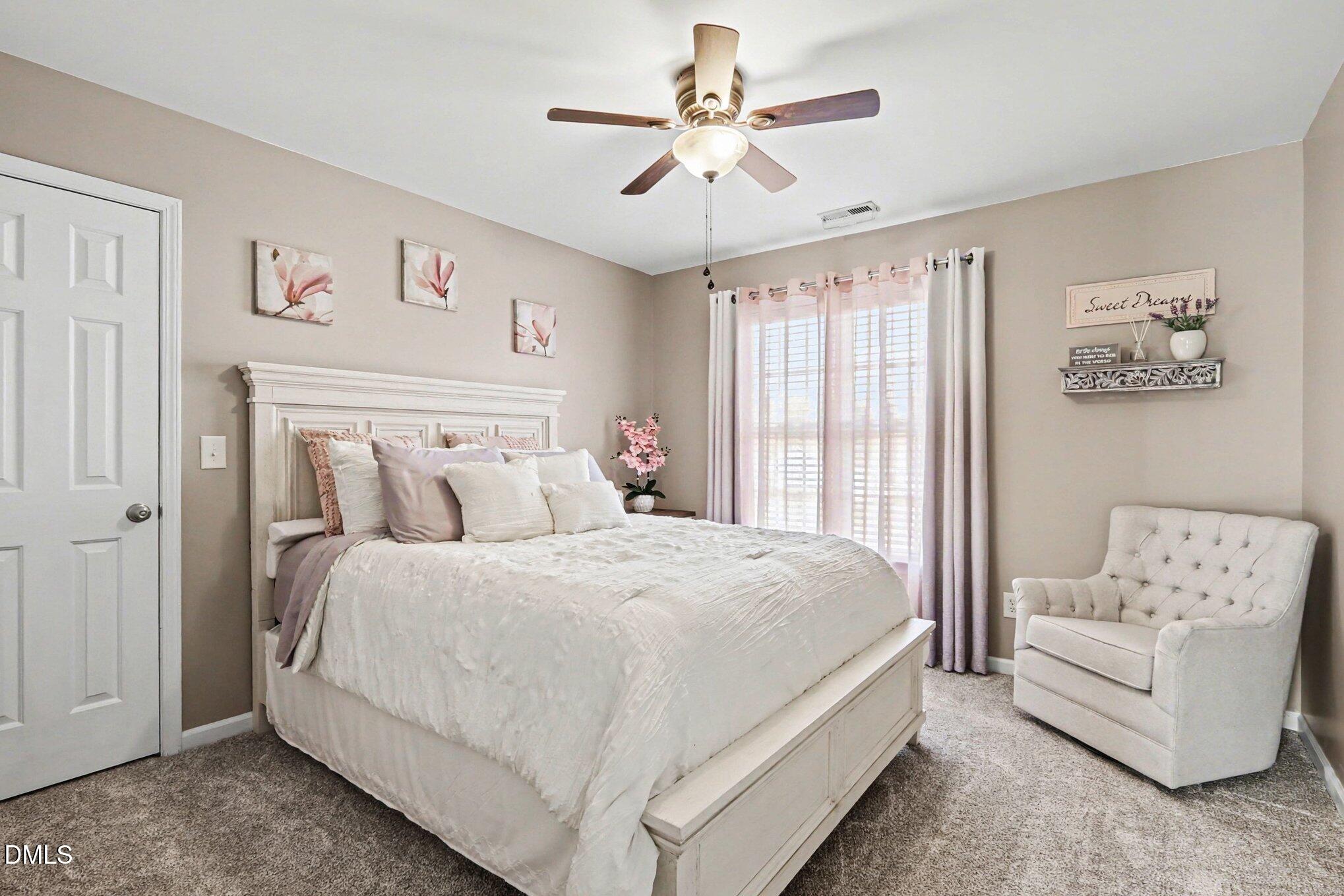 313 Blaze Ridge Drive Smithfield, NC 27577 - Photo 14 of 30 a spacious bedroom with a bed and a couch