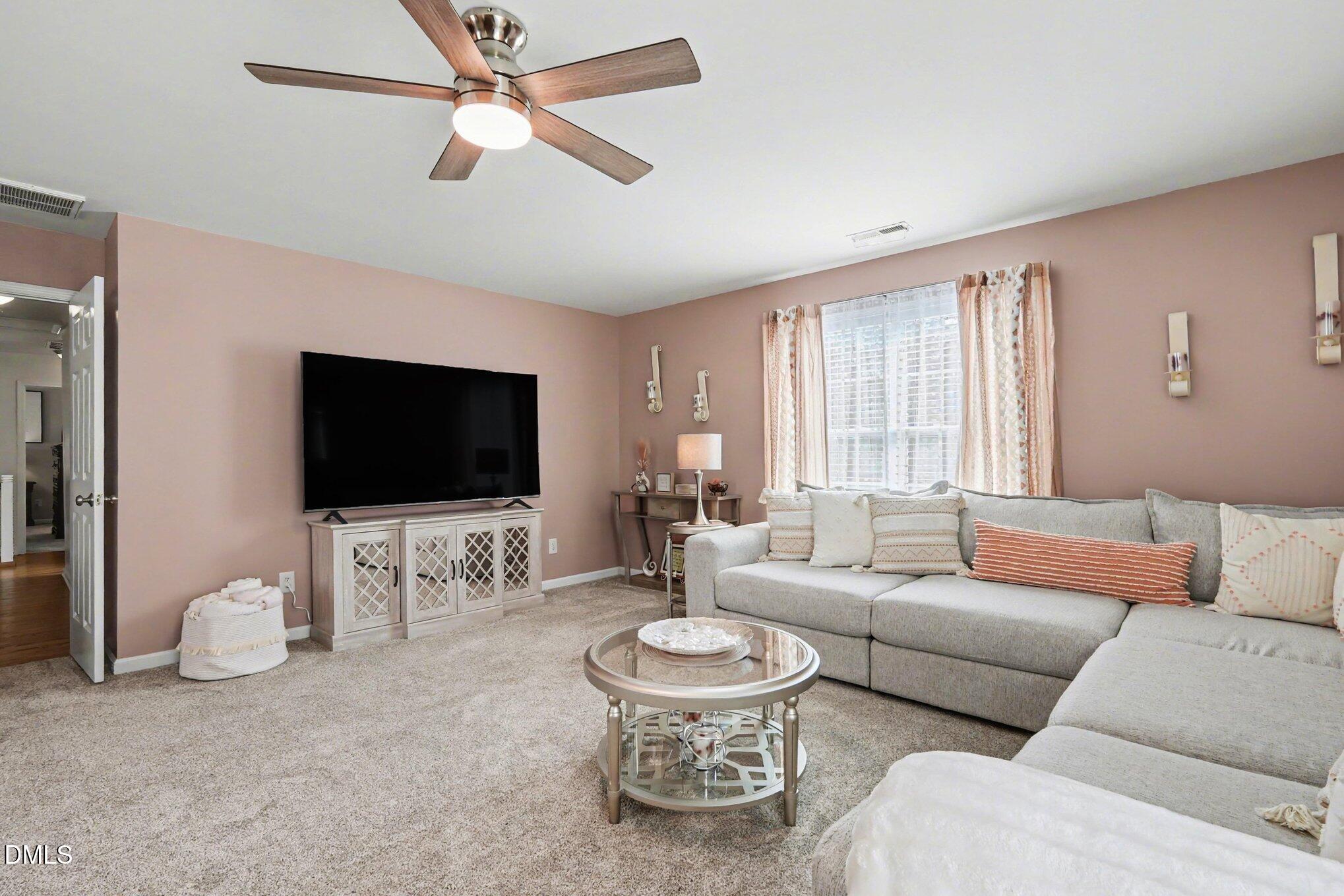 313 Blaze Ridge Drive Smithfield, NC 27577 - Photo 16 of 30 a living room with furniture and a flat screen tv