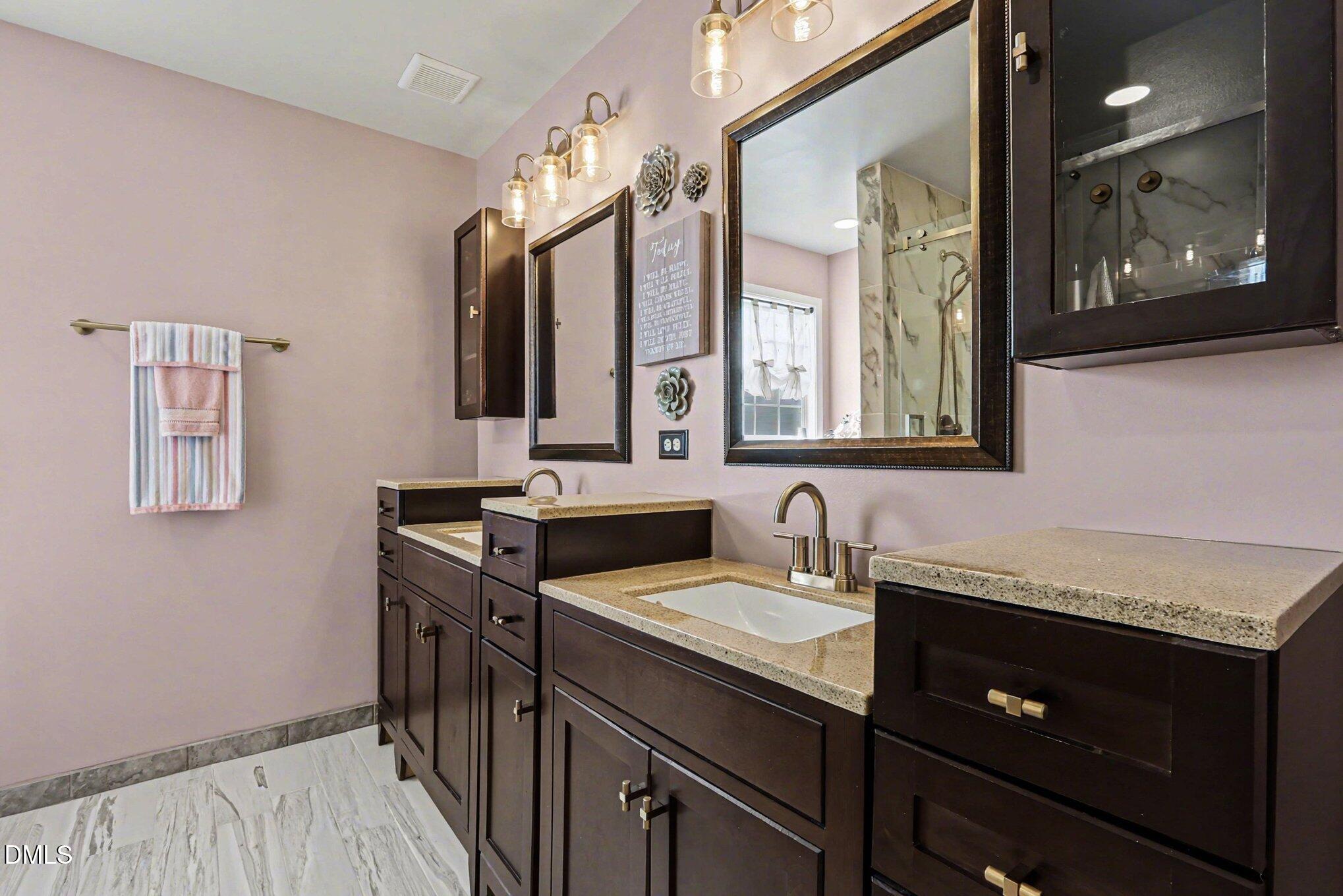 313 Blaze Ridge Drive Smithfield, NC 27577 - Photo 17 of 30 a bathroom with a sink double vanity and a mirror