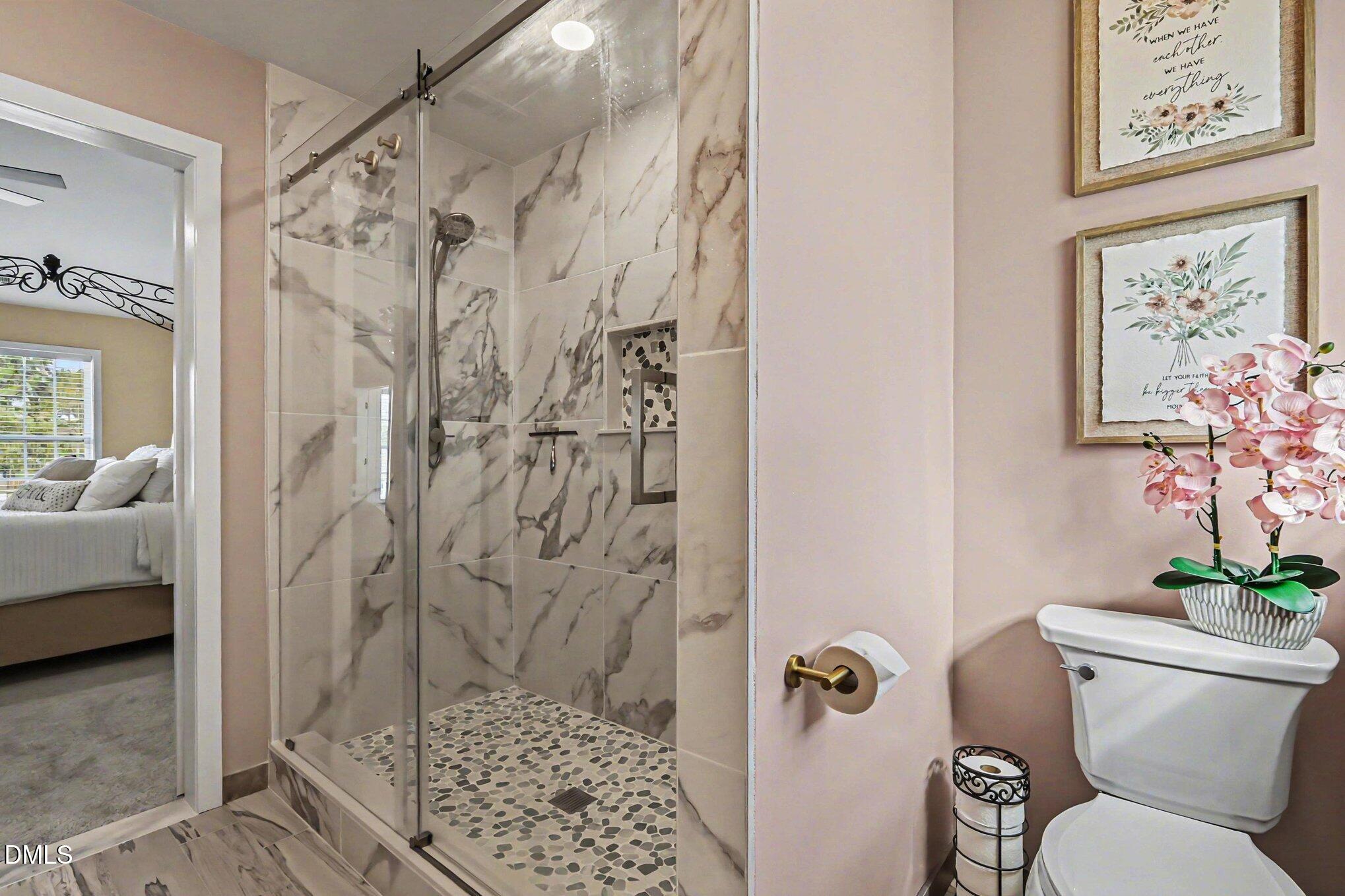 313 Blaze Ridge Drive Smithfield, NC 27577 - Photo 18 of 30 a bathroom with a shower and a toilet
