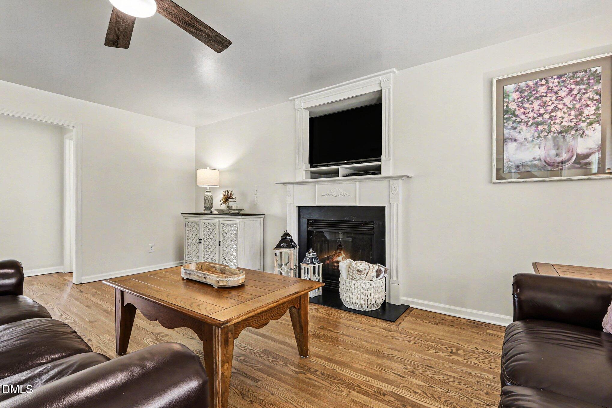 313 Blaze Ridge Drive Smithfield, NC 27577 - Photo 4 of 30 a living room with furniture and a fireplace
