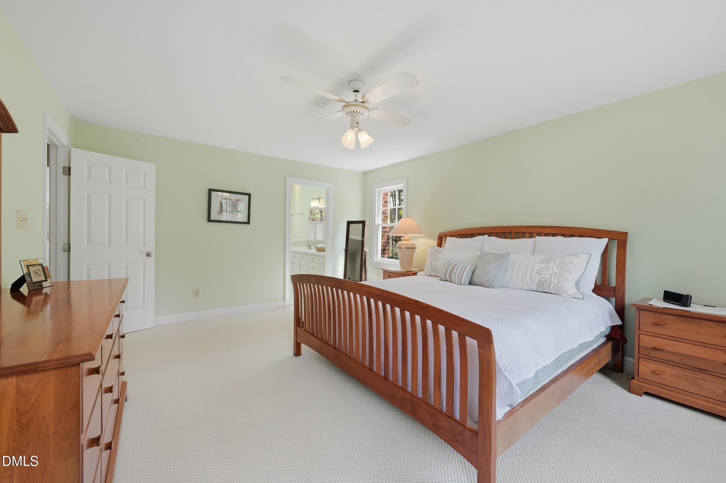 4001 Stemmons Court Raleigh, NC 27613 - Photo 17 of 45 a spacious bedroom with a bed and a chandelier