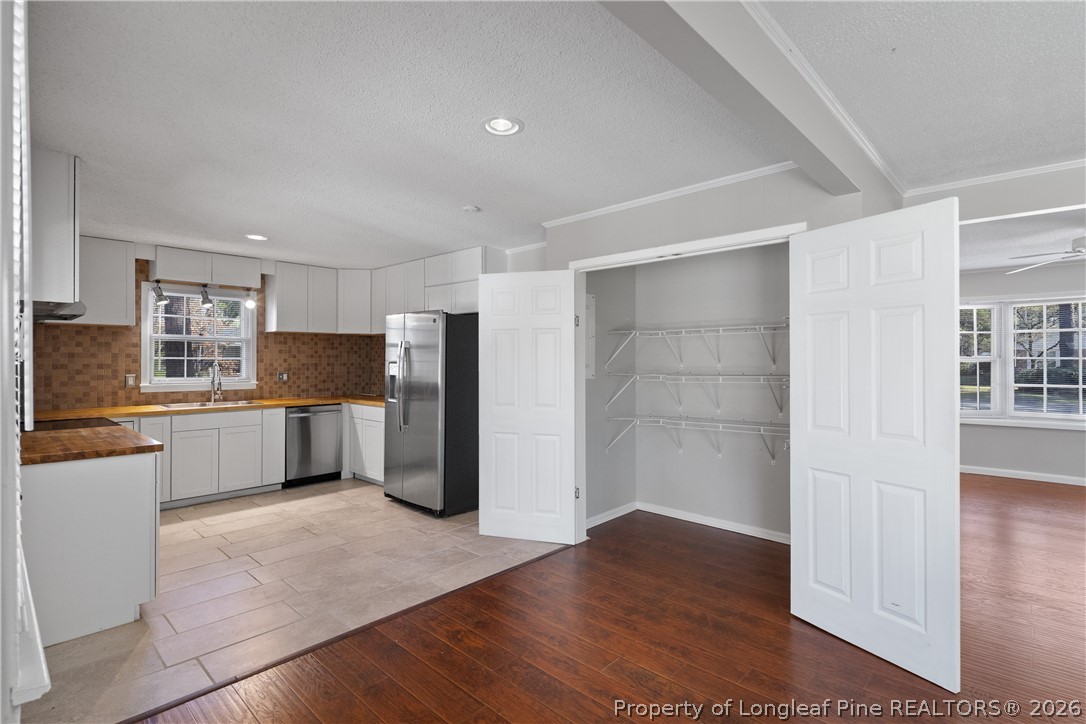 400 Hallmark Road Fayetteville, NC 28303 - Photo 12 of 37 a kitchen with stainless steel appliances a refrigerator and wooden floor