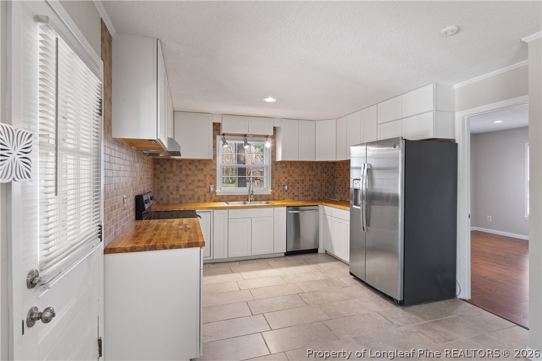 400 Hallmark Road Fayetteville, NC 28303 - Photo 14 of 37 a kitchen with stainless steel appliances a refrigerator sink and cabinets
